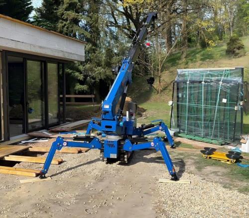 mini crawler crane with extended outriggers for stability on residential construction sites.