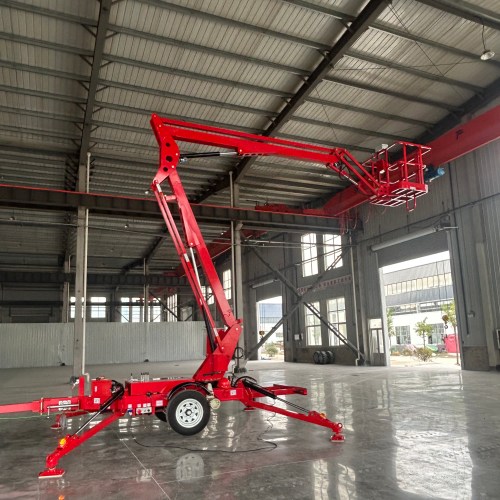 towable boom lift with articulated boom raised